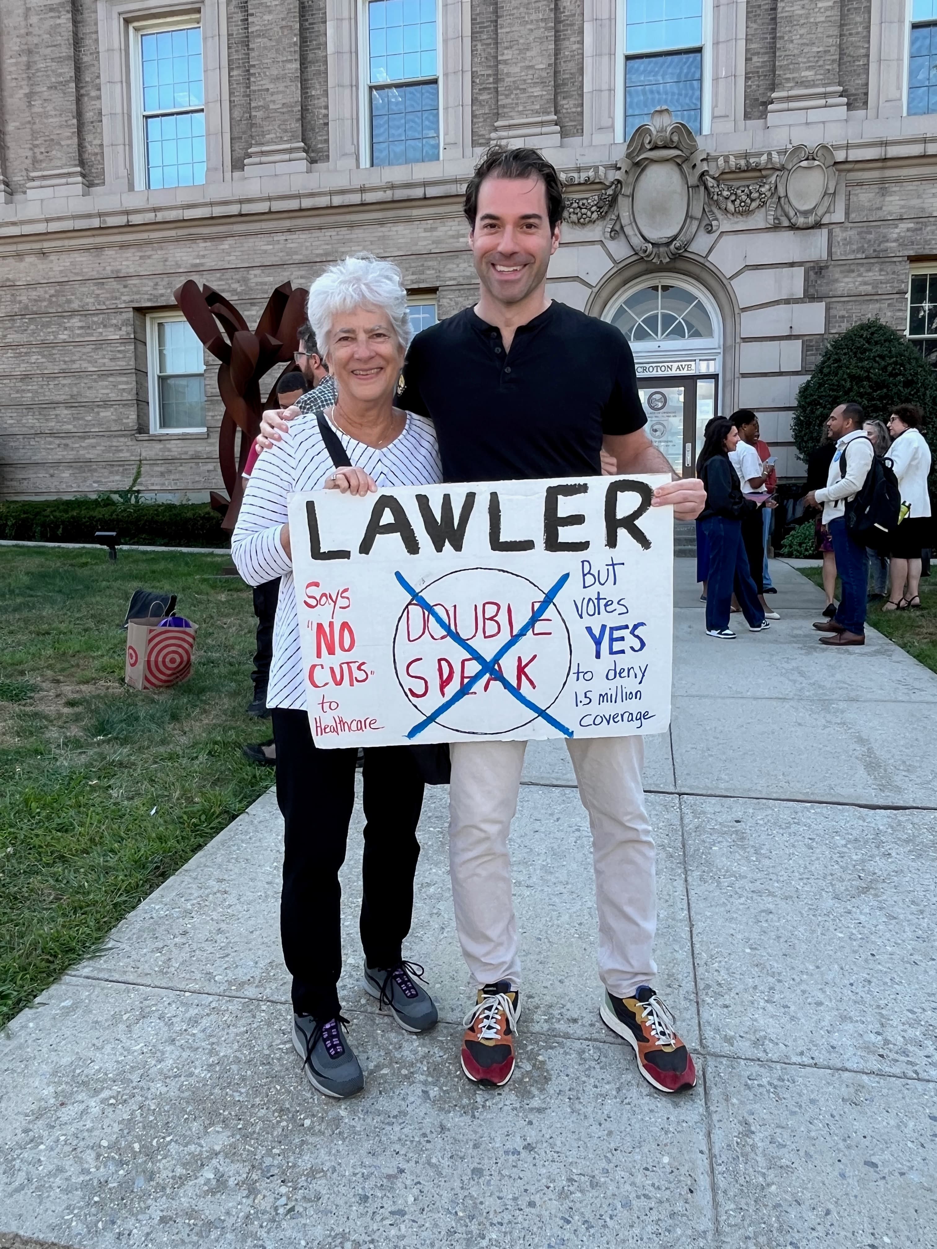 Mike Sacks with constituent holding sign calling out Mike Lawler healthcare doublespeak in Westchester County